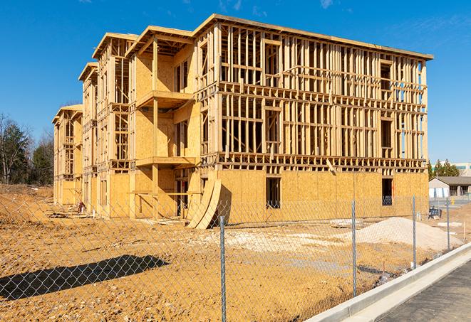 a construction site enclosed by temporary chain link fences, ensuring safety for workers and pedestrians in Broadview IL